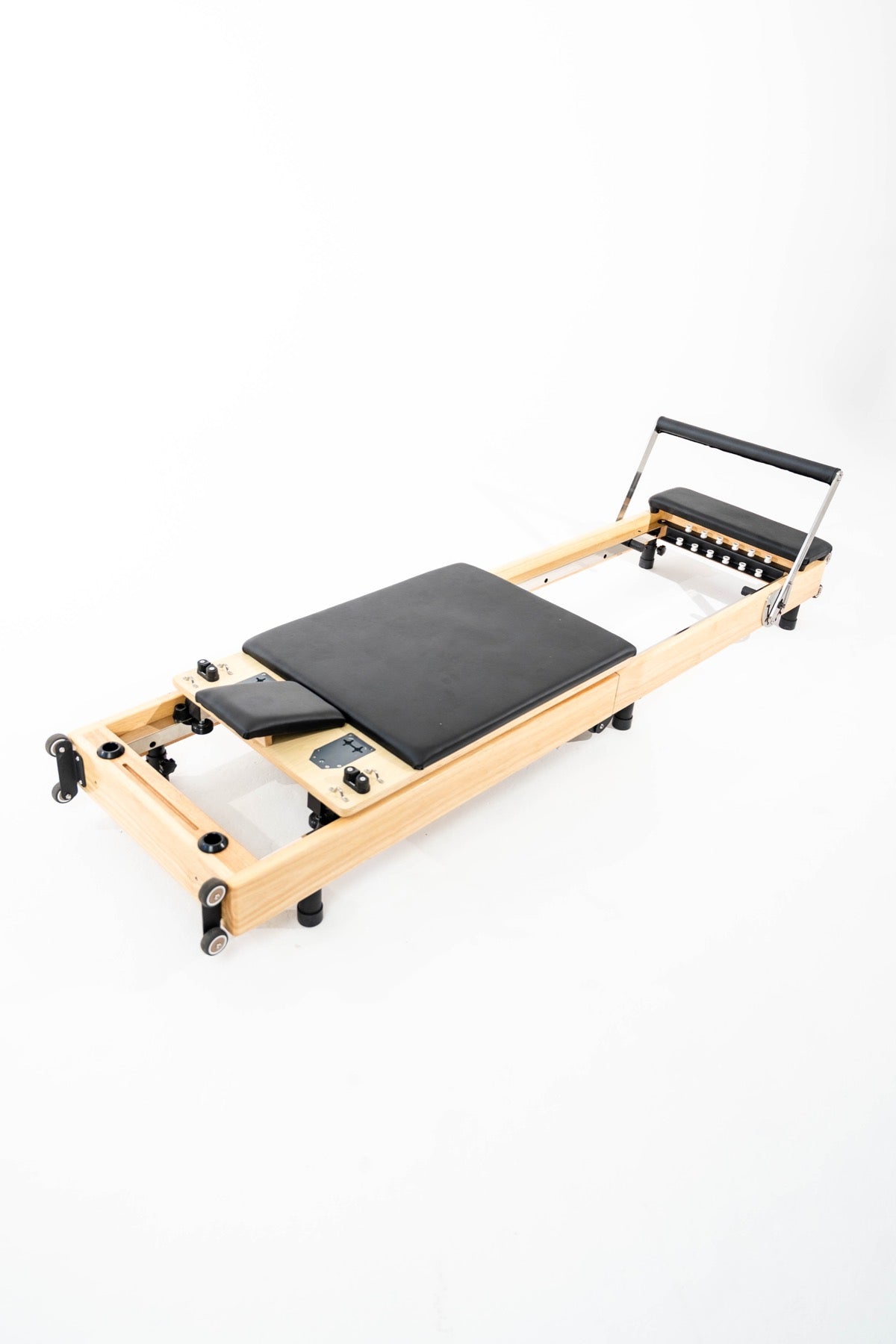 A solid wood home reformer with a real spring system